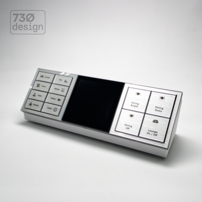 ControlBase Fit desktop mount in white with silver Dynalite Revolution EU Triple Gang panel installed - front angled view showing three joined modules: 8-button, display, and 4-button