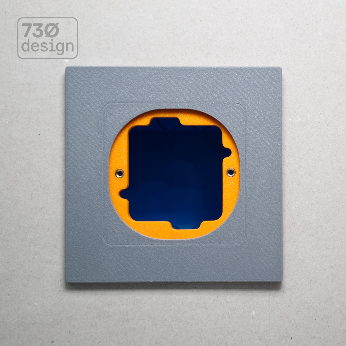 ControlFix NA 2-Gang adapter plate in grey-toned finish - front view before panel installation, showing orange mounting plate through cutout. Compatible with Dynalite Revolution Display (PDRDE), Revolution Button EU (PDRxE), and Dynalite Antumbra EU panels