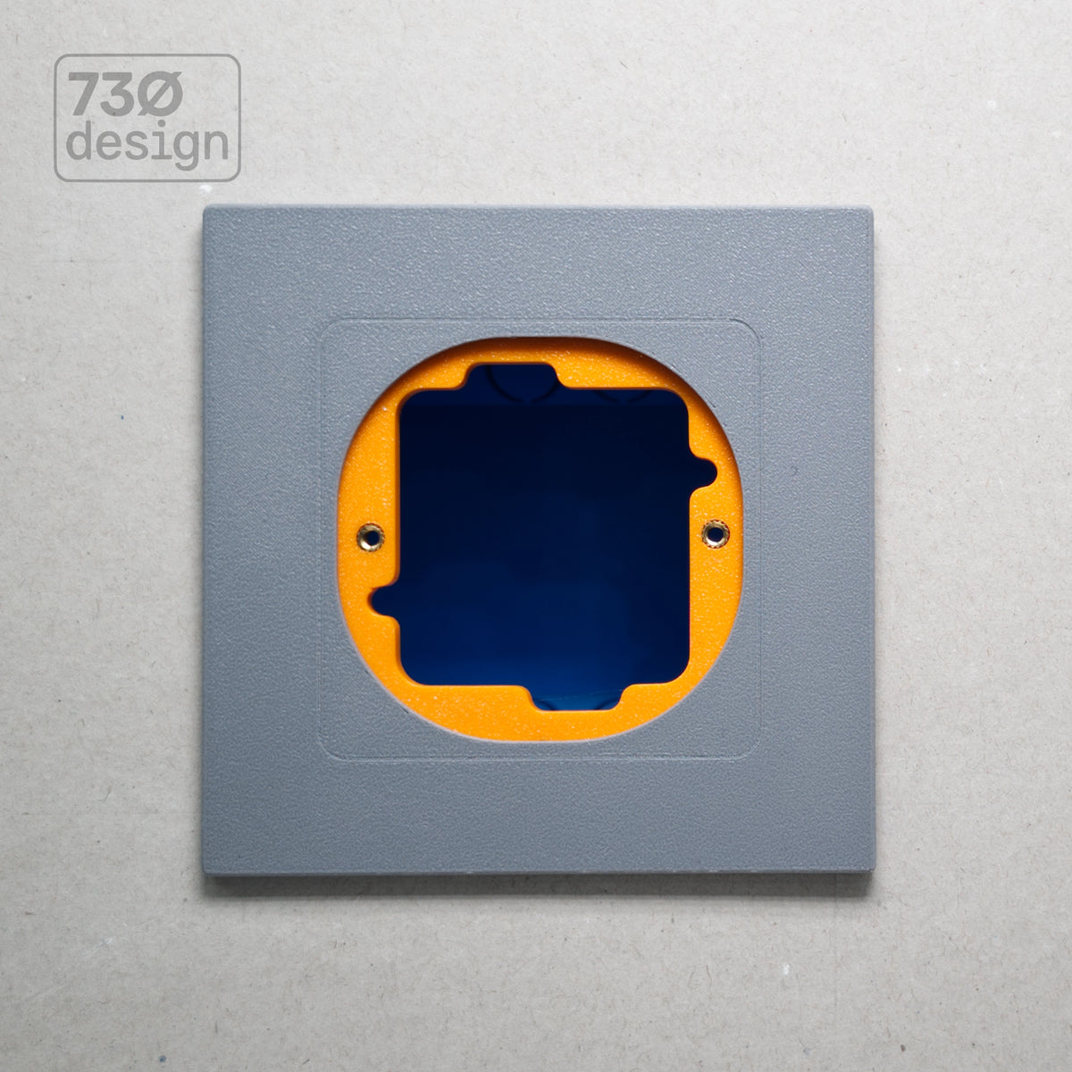 ControlFix NA 2-Gang adapter plate in grey-toned finish - front view before panel installation, showing orange mounting plate through cutout. Compatible with Dynalite Revolution Display (PDRDE), Revolution Button EU (PDRxE), and Dynalite Antumbra EU panels