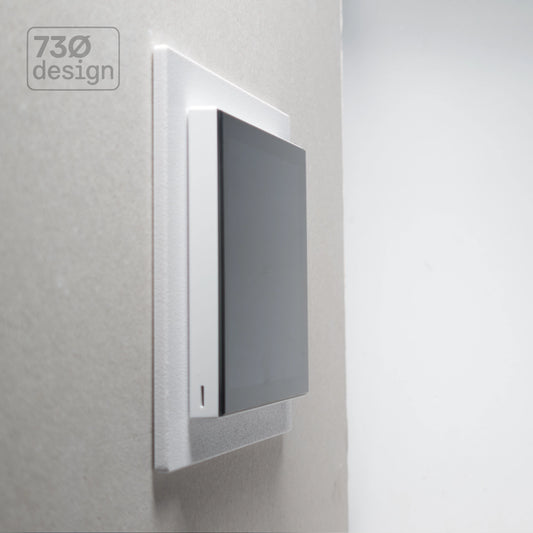ControlFix NA 2-Gang Type 86 adapter plate in white - angled view showing Dynalite Revolution EU panel installed on a wall, 60.3mm (60mm) fixing centres. Compatible with Revolution Display (PDRDE), Revolution Button EU (PDRxE), and Dynalite Antumbra EU panels
