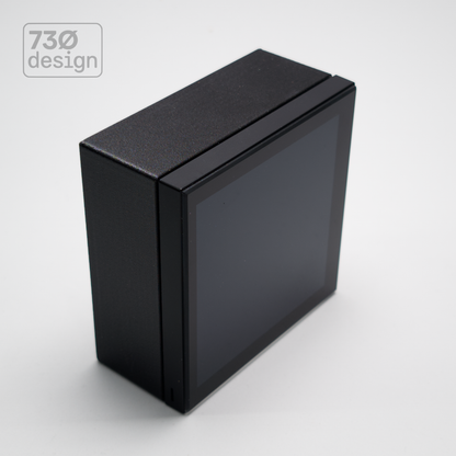 ControlSurface Fit surface-mount bracket in Obsidian Black with Dynalite Revolution EU touchscreen panel installed - front angled view. Compatible with Revolution Display EU PDRDE and Revolution EU button panels, 60.3mm (60mm) Type 86 fixing centres